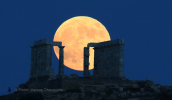 Moonrise of the fullmoon behind the temple of Poseidon at cape Sounio